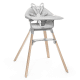 Stokke Clikk High Chair in gray with wooden legs, detachable tray, and 5-point harness for safe baby feeding.